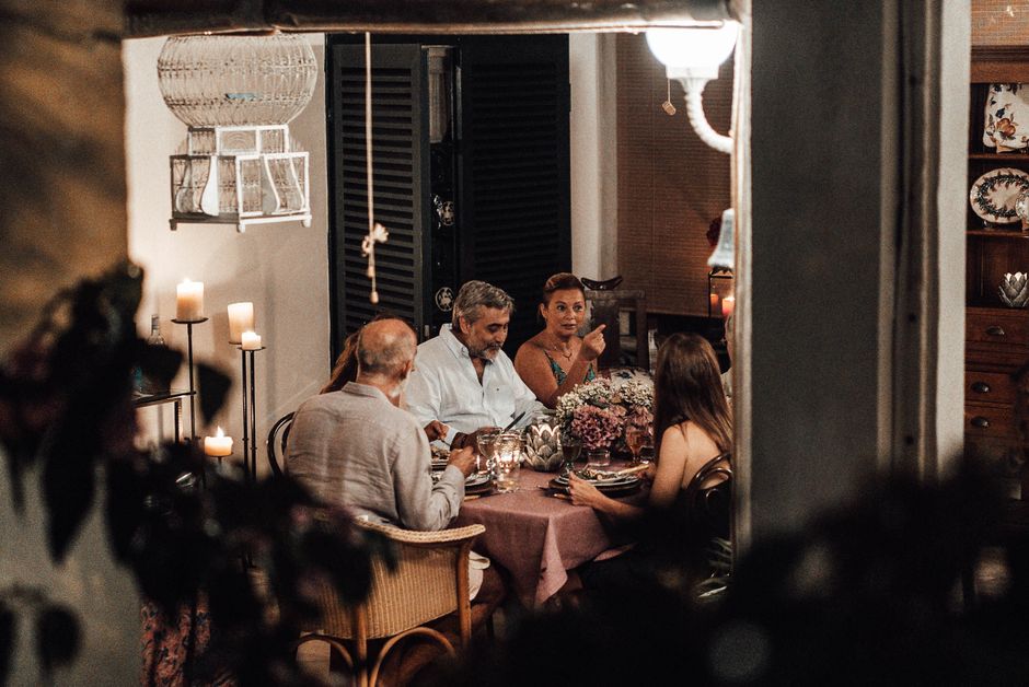 Warm and intimate family dinner with conversation and candlelight ambiance.